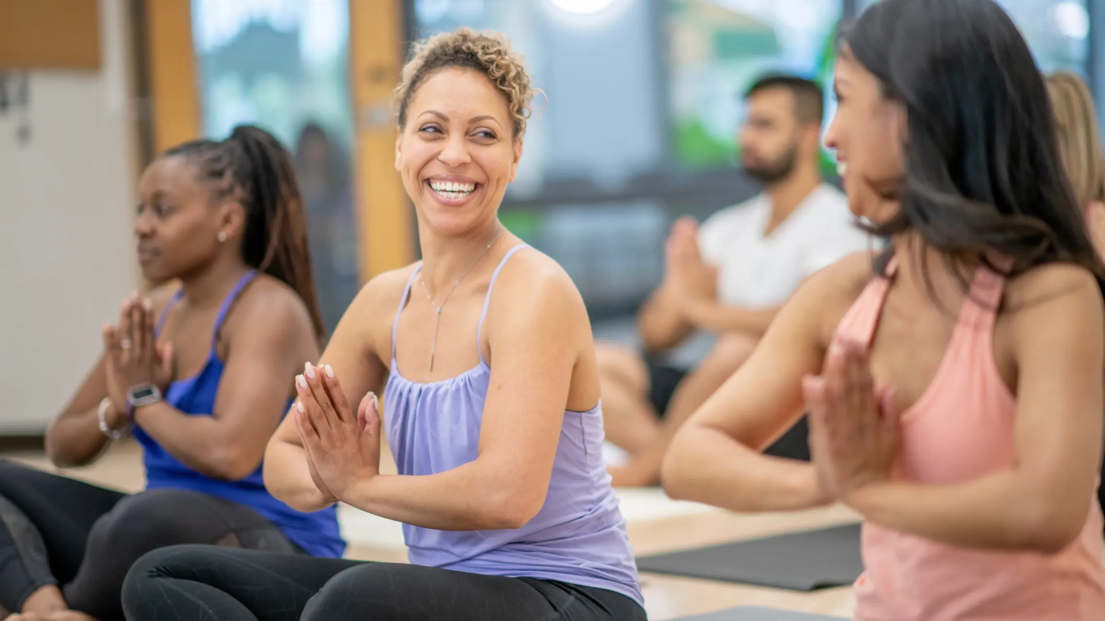 group of ladies practicing yoga