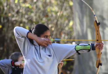 photo of a girl holding bow and arrow