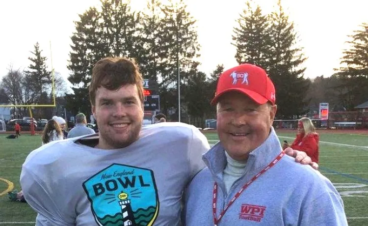 photo of father and son posing at college football game