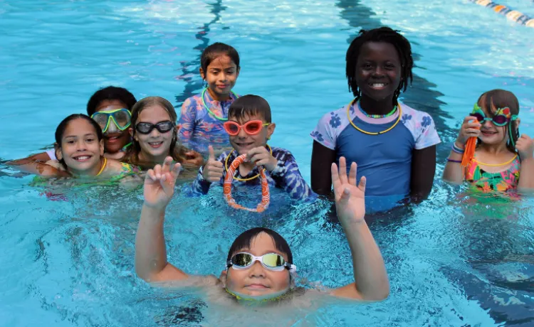 group photo of campers smiling in the pool