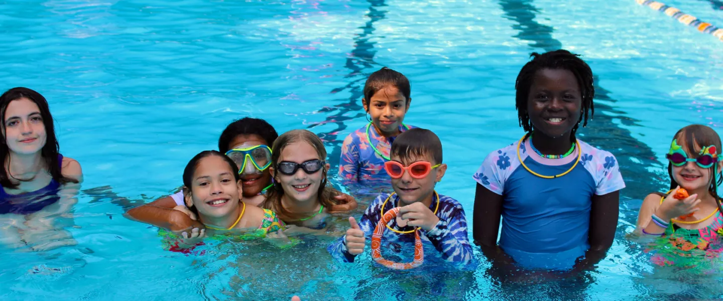 group photo of campers in the pool