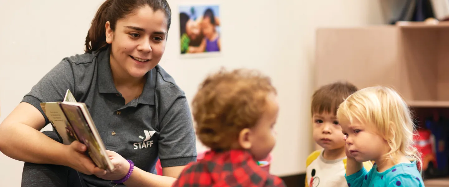 image of teacher reading to toddlers