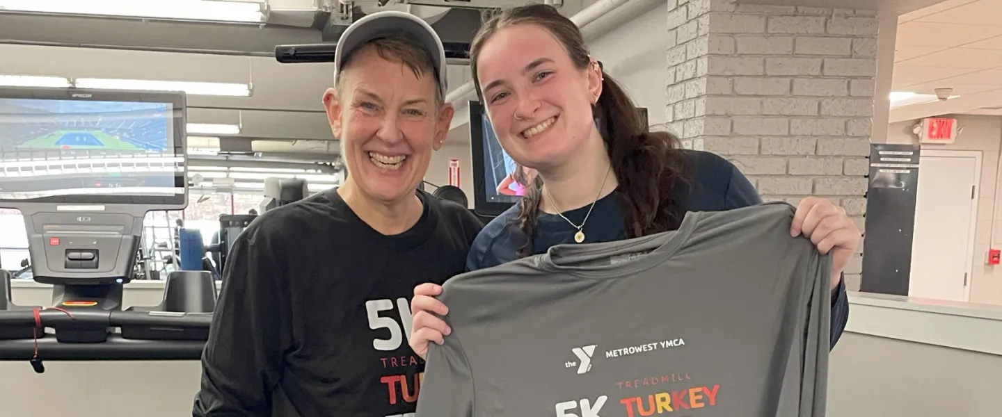 image of mother and daughter standing together in front of treadmills