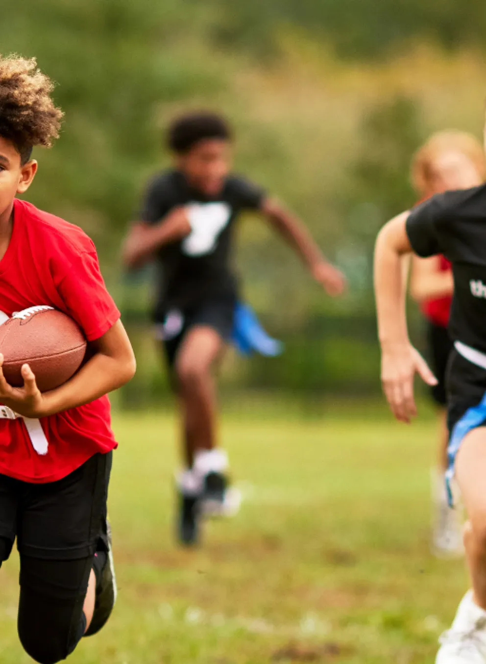 youth playing a game of flag football