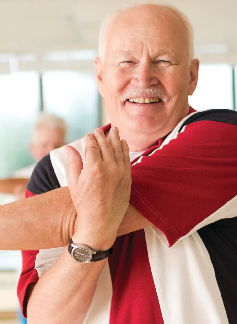 group of seniors stretching in wellness class