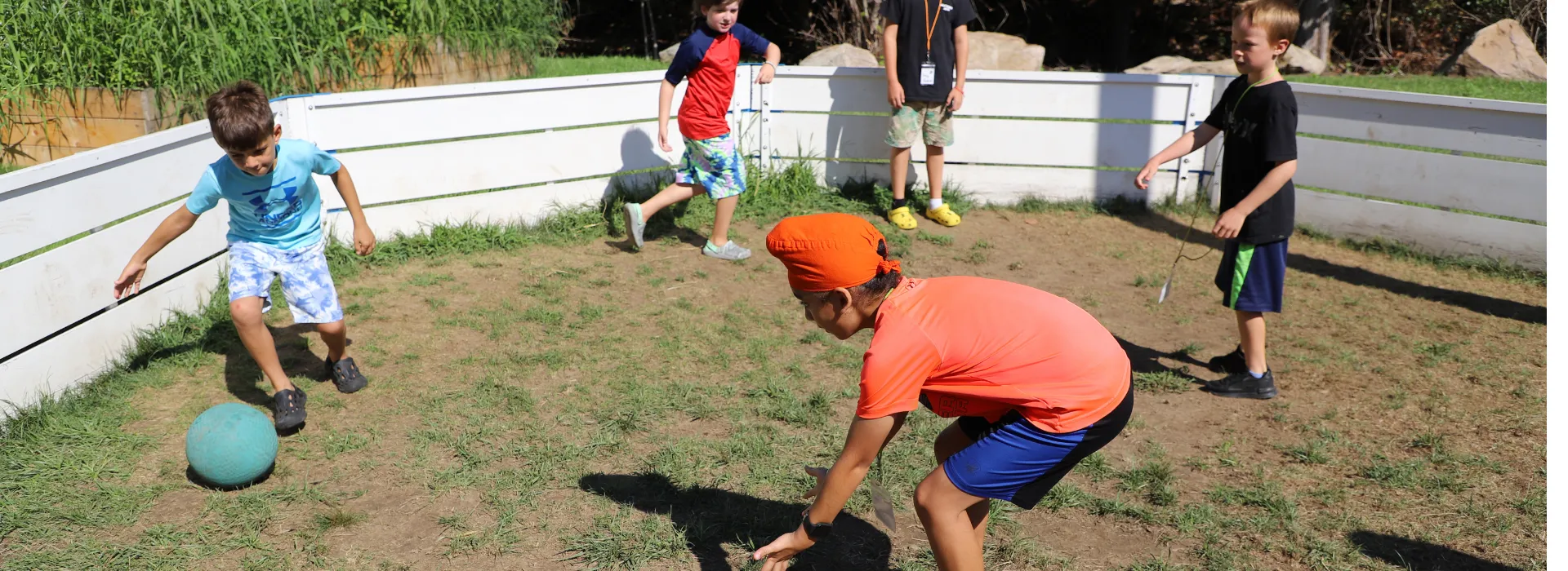 Campers work up a sweat in a lively game of gaga ball.