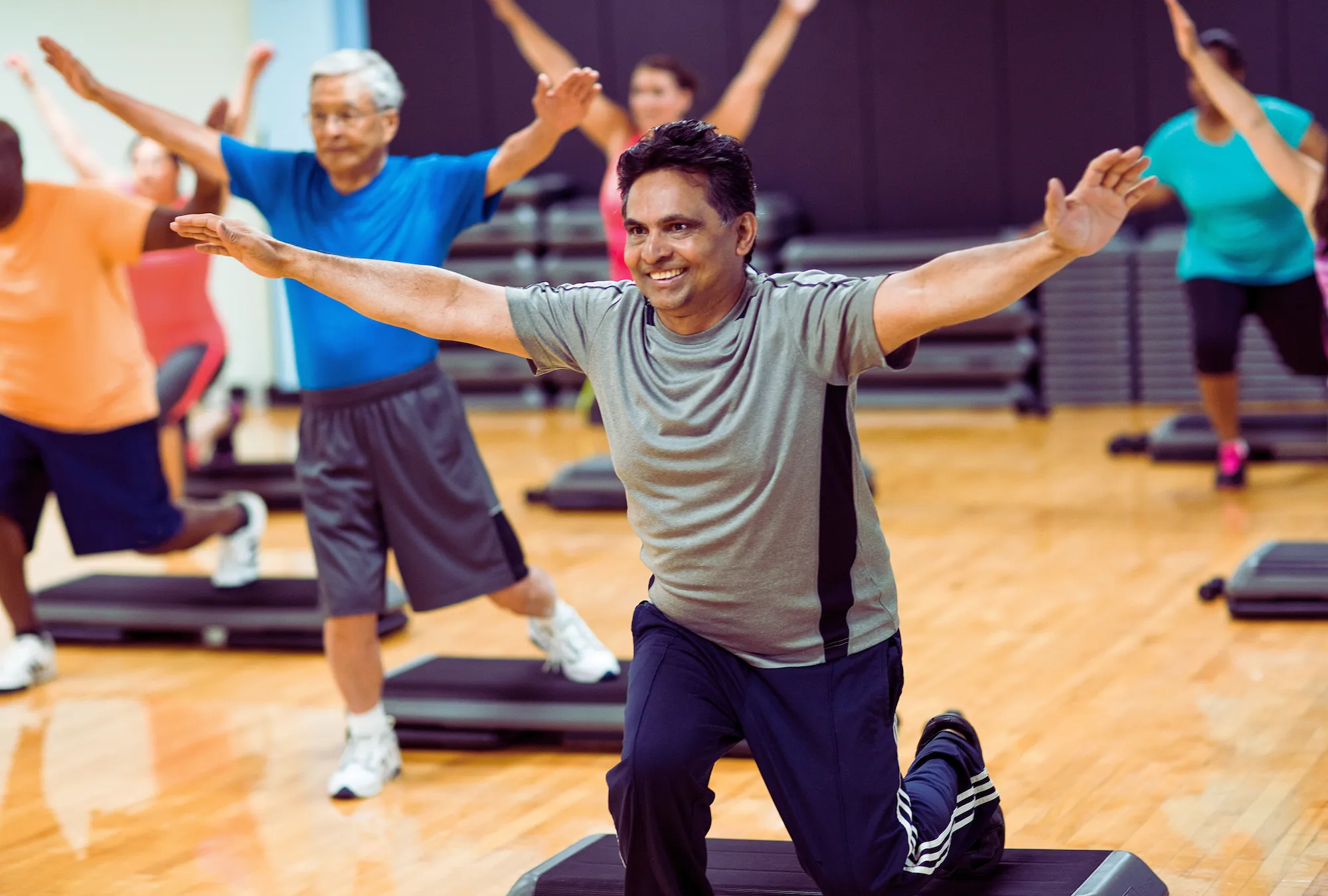 Group of all ages in a strength and weights group exercise class