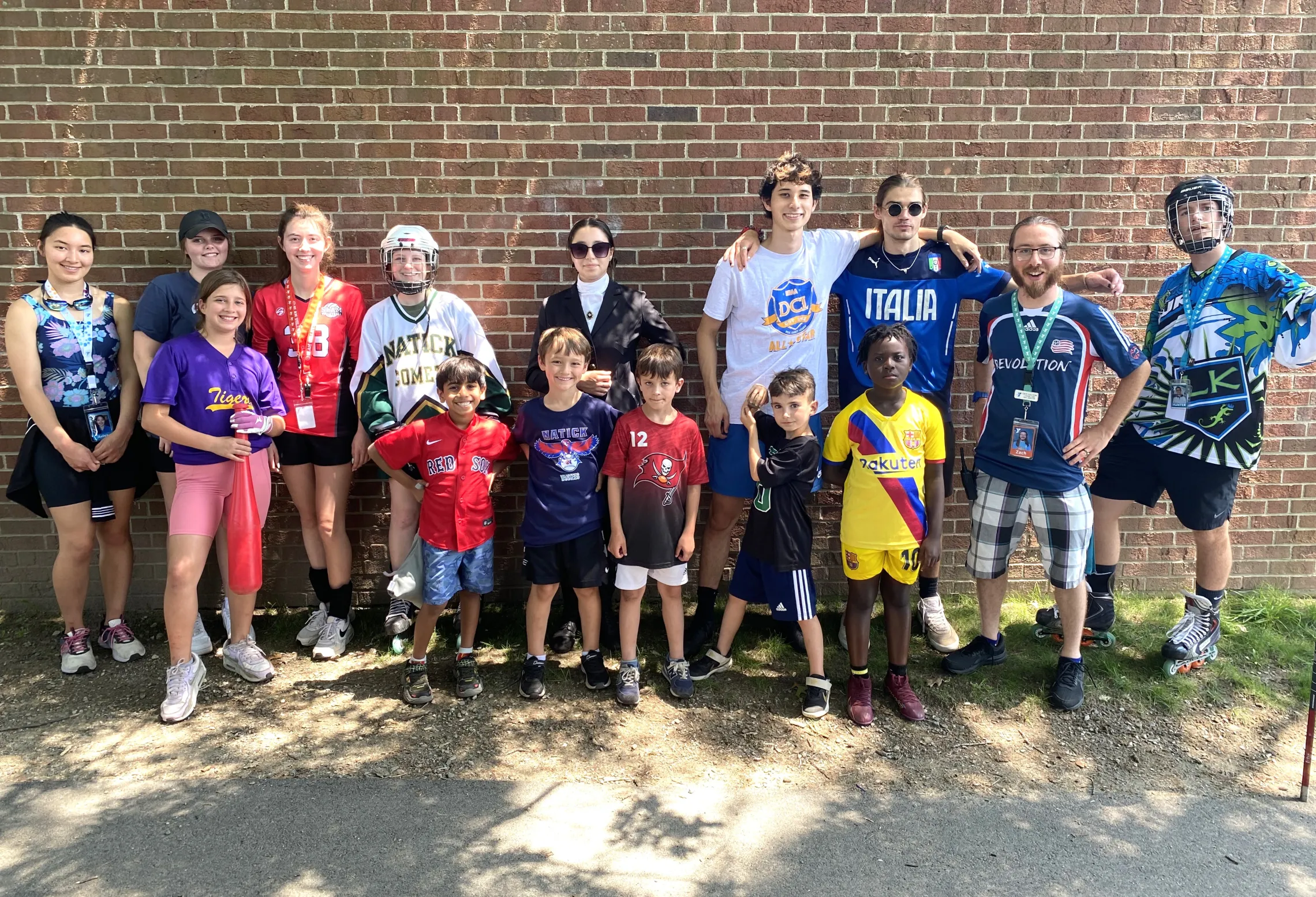 group photo of campers and camp counselors dressed in sports jerseys