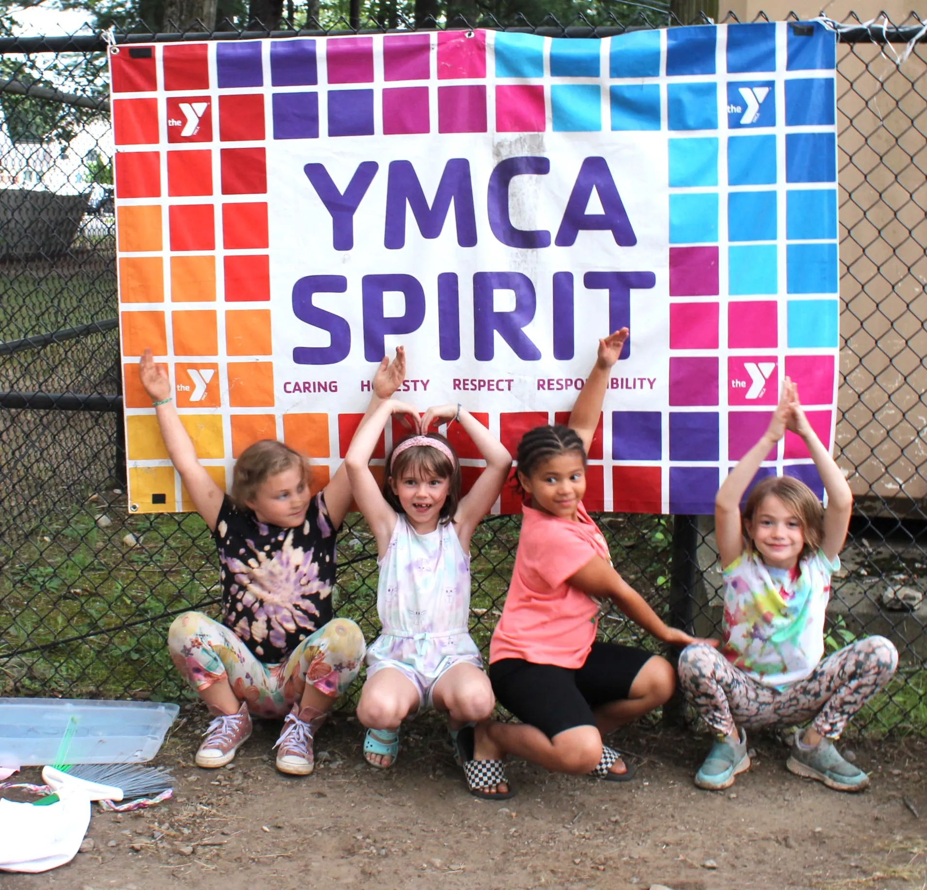 photo of campers in front of YMCA Spirit banner