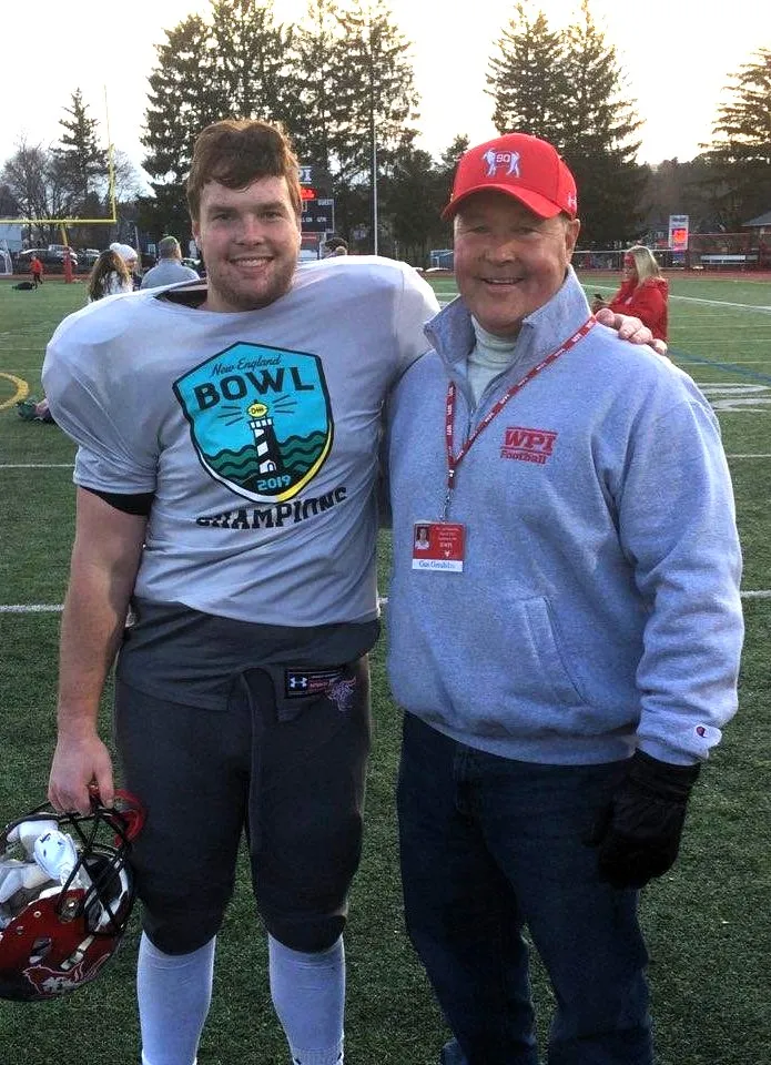 photo of father and son posing at college football game