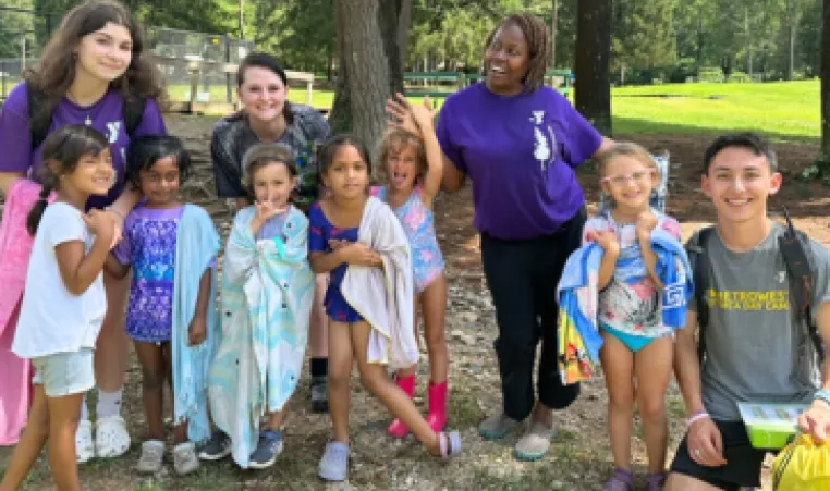 group photo of kids and camp counselors outside