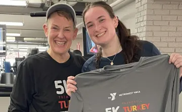 image of mother and daughter standing together in front of treadmills