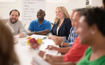 group of people sitting around a table as they learn about nutrition